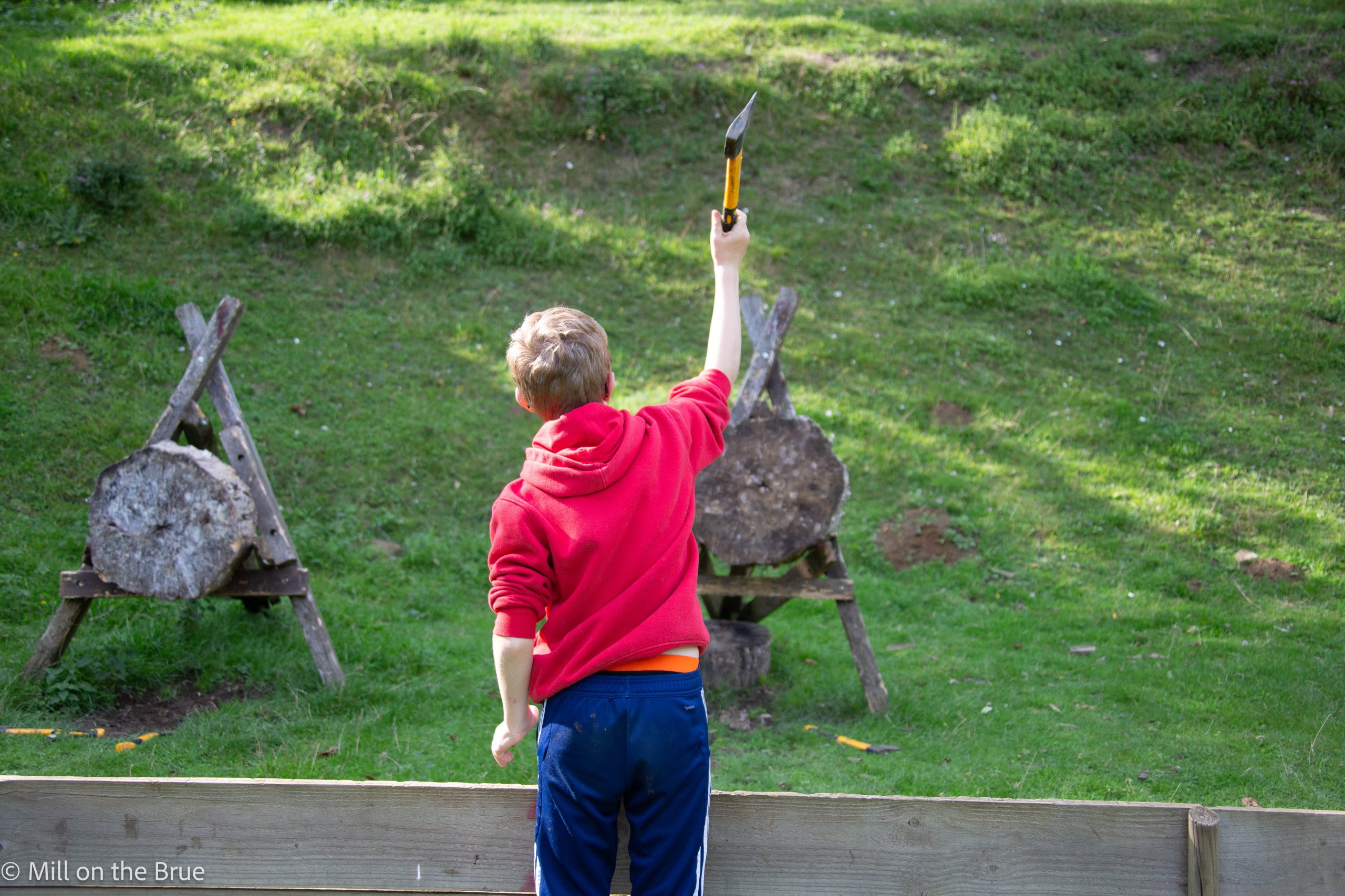 A student throws an axe at a target.