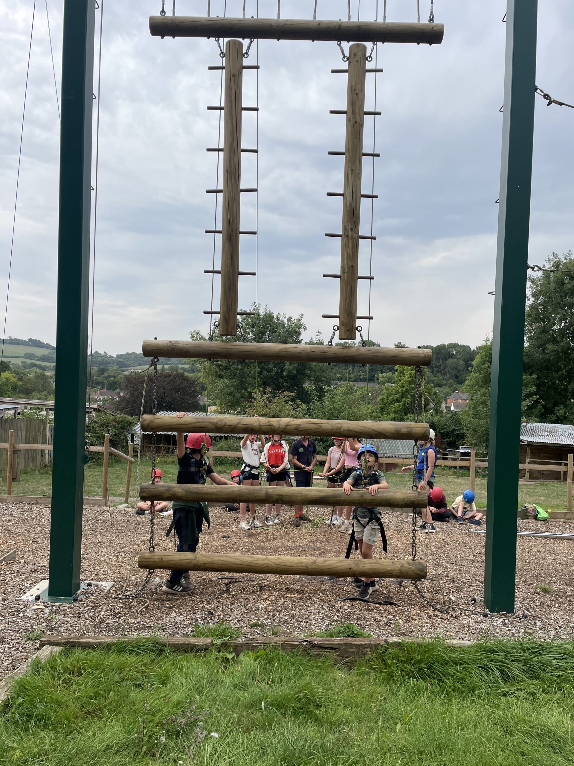 Children climb the gladiator wall.