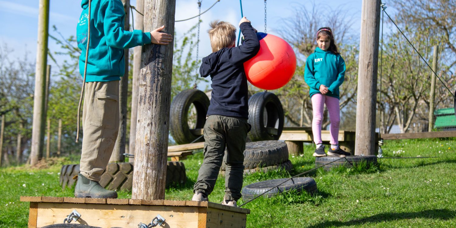 Children play on an obstacle course.