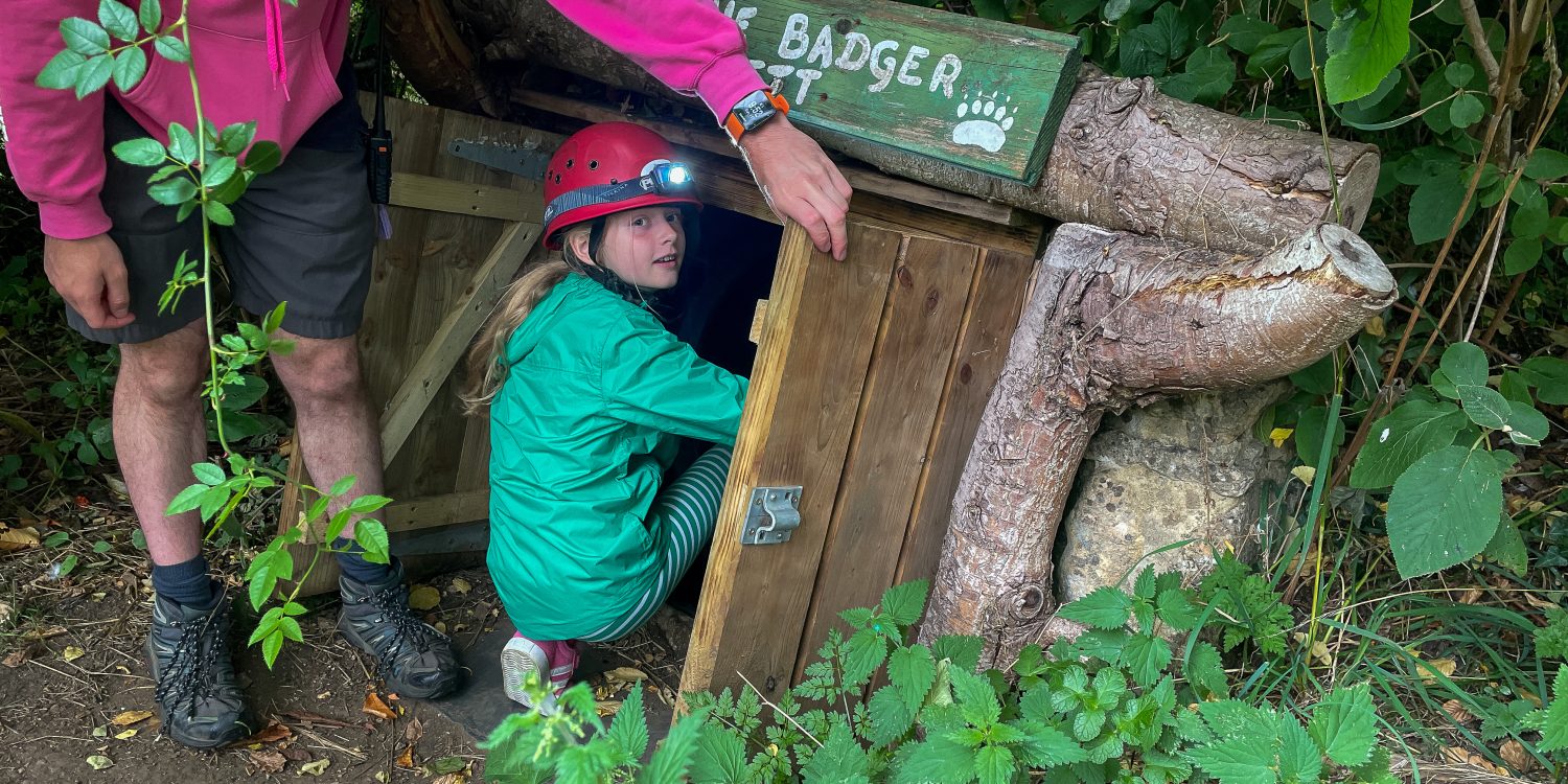 A child prepares to go into a tunnel.